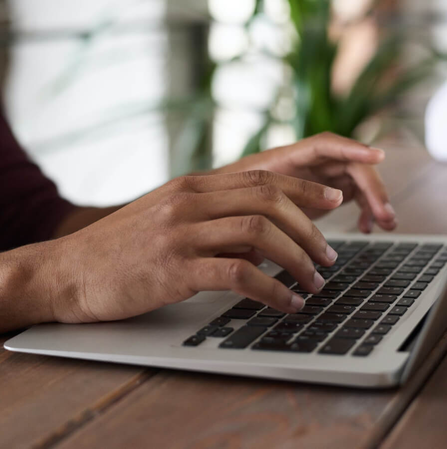 Person writing a message on a laptop